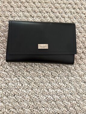 Kate Spade black leather wallet with metal logo plaque